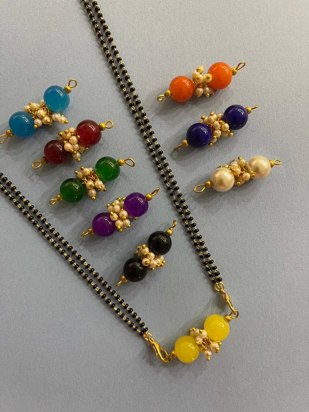 Modern Stylish Short Navaratri Mangalsutra Combo Set Multicolor 9 Changeable Pendant Simple Black Beads Chain